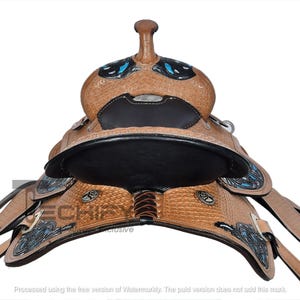 May include: A close-up of a brown leather western saddle with decorative silver and turquoise accents. The saddle features a black seat and intricate tooling. The saddle is designed for riding horses.