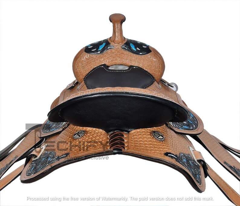 May include: A close-up of a brown leather western saddle with decorative silver and turquoise accents. The saddle features a black seat and intricate tooling. The saddle is designed for riding horses.