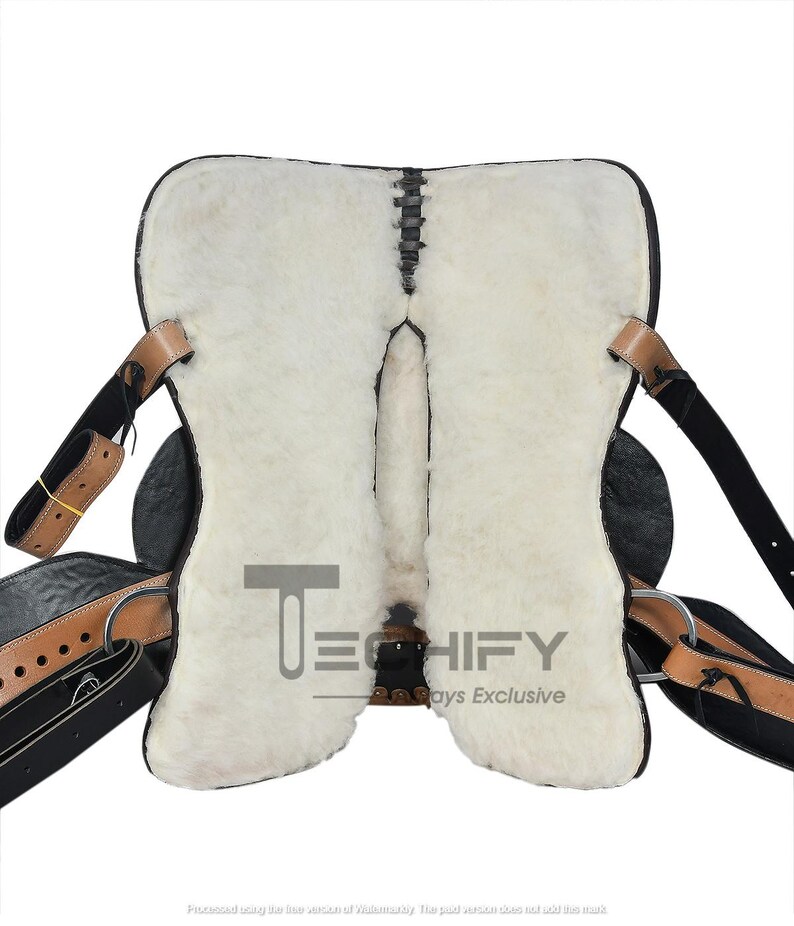 May include: A black and tan leather saddle with a white sheepskin lining. The saddle features leather straps, metal rings, and stitching details. The image includes the text "TECHIFY" and "Always Exclusive".