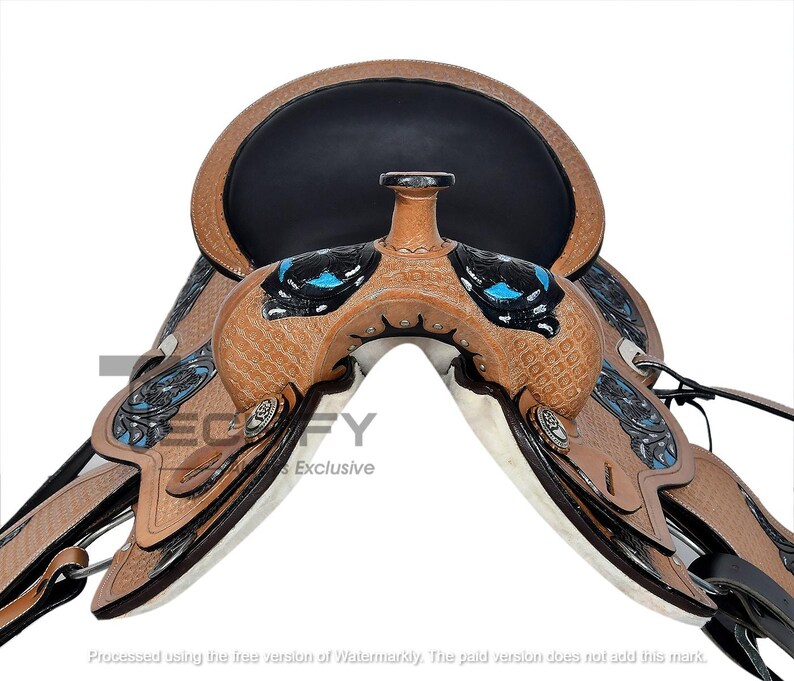 May include: A brown and black Western saddle with intricate tooling and turquoise accents. The saddle features a black seat and decorative silver-toned studs. The stirrups and other hardware are visible.