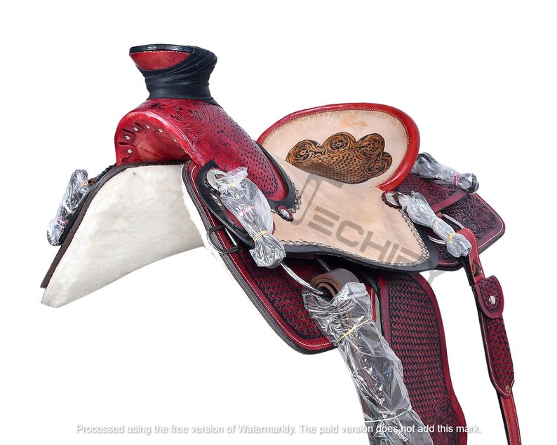 May include: A red and black leather saddle with intricate floral tooling. The saddle features a white fleece seat and a dark brown leather stirrup.