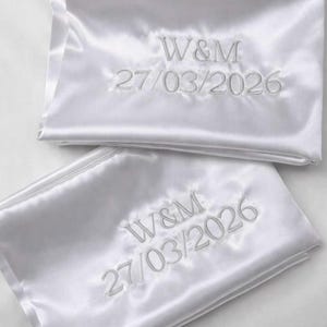Personalized Satin Pillowcases with Embroidered Initials and Special Date  Elegant satin pillowcases customized with embroidered initials and a meaningful date. These personalized pillowcases are perfect for celebrating special moments such as weddings, engagements, anniversaries, or other memorable occasions. The soft satin fabric and delicate embroidery create a timeless and sophisticated keepsake. Soft and smooth satin fabric