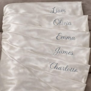 Personalized Satin Pillowcases with Embroidered Names  Elegant satin pillowcases customized with beautifully embroidered names. These personalized pillowcases are perfect as bridesmaid gifts, bridal party gifts, or special keepsakes for friends and family. The soft satin fabric combined with delicate embroidery creates a thoughtful and sophisticated gift for weddings and special occasions.