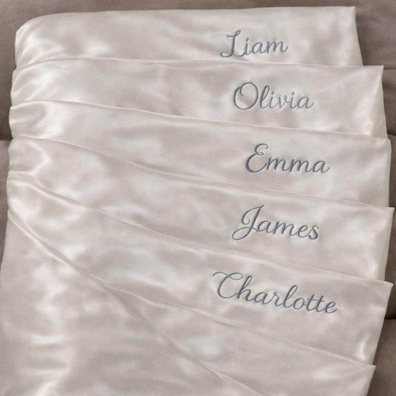 Personalized Satin Pillowcases with Embroidered Names  Elegant satin pillowcases customized with beautifully embroidered names. These personalized pillowcases are perfect as bridesmaid gifts, bridal party gifts, or special keepsakes for friends and family. The soft satin fabric combined with delicate embroidery creates a thoughtful and sophisticated gift for weddings and special occasions.