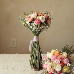 custom medium dried wildflower bridesmaid bouquets in colors of creamy white, peach, blush and pink. Seasonal wildflower wedding decor.