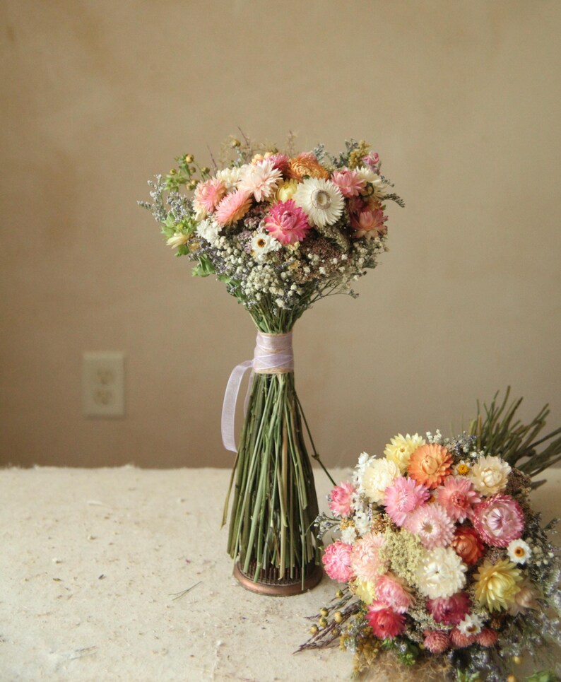 custom medium dried wildflower bridesmaid bouquets in colors of creamy white, peach, blush and pink. Seasonal wildflower wedding decor.