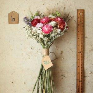 This photo features variation B of the listing, entitled Boho Mix. a bouquet containing a mix of red, bright and deep pink and blush strawflowers, daisies, baby's breath and wildflowers. Boho home and wedding decor. Mother's Day florals, one of a kind seasonal home and wedding decor.
