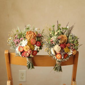 Autumnal inspired chair bouquets. Wedding aisle floral decor. Mix of dried peonies, strawflowers, gypsophila, ammobium, gomphrena, caspia, yarrow and wild grasses. Fully customized wedding decor. Organically and sustainably grown.