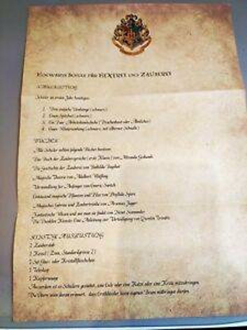 May include: A list of required items for a student attending Hogwarts School of Witchcraft and Wizardry. The list includes items such as a wand, robes, cauldron, and a telescope. The list is written in a handwritten font on a parchment background with the Hogwarts crest at the top.
