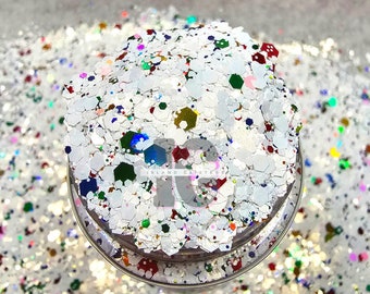 May include: White glitter with multi-colored glitter flakes. The glitter is in a clear jar with a silver lid. The jar has the text "Island Glitter" on it.