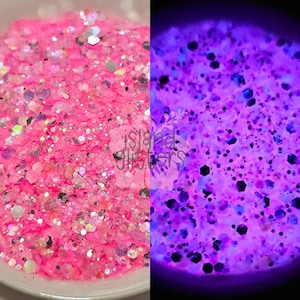 Puede incluir: Primer plano de purpurina rosa con varias formas y tamaños. La purpurina se muestra con luz normal y con luz negra, revelando un efecto púrpura brillante. El texto "Island Glitters" es visible.