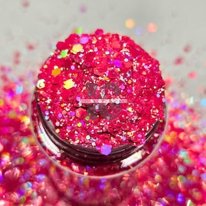 May include: A jar filled with vibrant, hot pink glitter. The glitter is a mix of shapes and sizes, reflecting light with a rainbow sheen. The jar is clear, and the glitter spills out around the edges, creating a dazzling effect. Ideal for crafts and decorations.