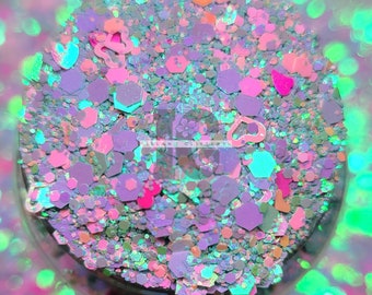 May include: A close-up of iridescent glitter in various shapes and sizes, including hearts, hexagons, and irregular shapes. The glitter is a mix of pink, purple, blue, and green colors.