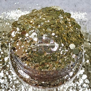 May include: A close-up of a jar filled with gold glitter. The glitter is a mix of different sizes and shapes, creating a shimmering effect.