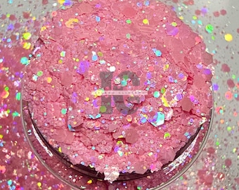 May include: Pink glitter with iridescent holographic flakes. The glitter is in a clear jar with a white background.