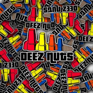 May include: A collection of colorful stickers with the phrase "DEEZ NUTS" in bold, white letters with a black outline. The stickers feature a cartoon design of various colored shapes, including red, yellow, orange, blue, and brown.