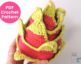 May include: A crocheted pineapple with a green top and a red base. The pineapple is made with yarn and is a handmade craft.