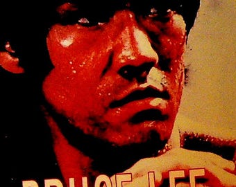 May include: A close-up image of Bruce Lee with the text "BRUCE LEE" in large, yellow letters. The image has a red and black color scheme, with the text "THEY DIED TOO YOUNG" at the top.