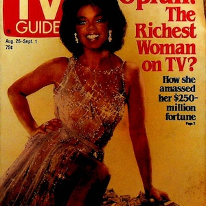 May include: A magazine cover featuring Oprah Winfrey, with the headline "Oprah! The Richest Woman on TV?" and the text "How she amassed her $250-million fortune". Oprah is wearing a sparkly silver dress and sitting on a pile of money.