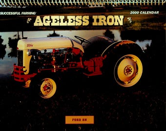 May include: A calendar featuring a vintage Ford 8N tractor. The tractor is cream and red, with the Ford logo visible. The calendar title reads "Ageless Iron" and "2000 Calendar". The background shows a body of water and trees.