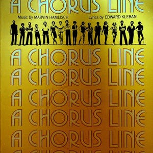 May include: A vintage book cover for "A Chorus Line" musical. The cover is a golden yellow with the title in large, stylized letters. The top features the text "VOCAL SELECTIONS" and the names of the production team. Silhouetted figures of dancers are at the top.