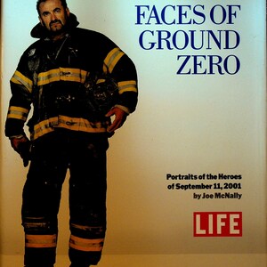 May include: A book titled "Faces of Ground Zero: Portraits of the Heroes of September 11, 2001" by Joe McNally, with a tribute from Rudolph W. Giuliani. The cover features a photograph of a firefighter in full gear.