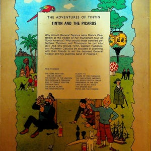 May include: Back cover of "The Adventures of Tintin: Tintin and the Picaros" comic book. Features a colorful illustration with characters, a parrot, a plane, and text describing the story. Includes a list of other Tintin titles.