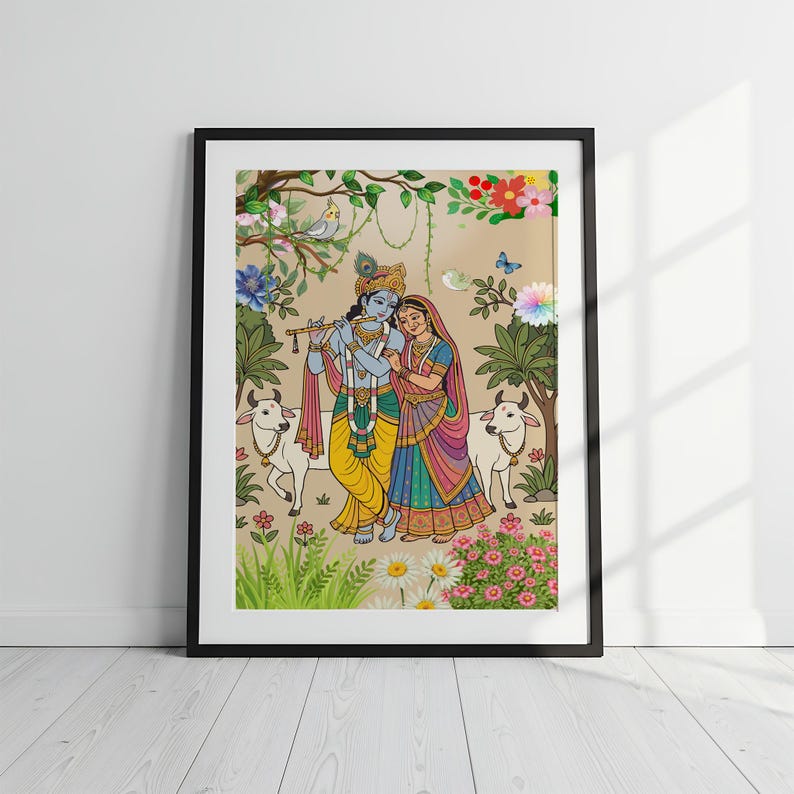 May include: Framed artwork depicting a couple in traditional Indian attire, surrounded by flowers, trees, and cows. The man plays a flute, while the woman stands beside him. The artwork is in a black frame and set against a white wall.
