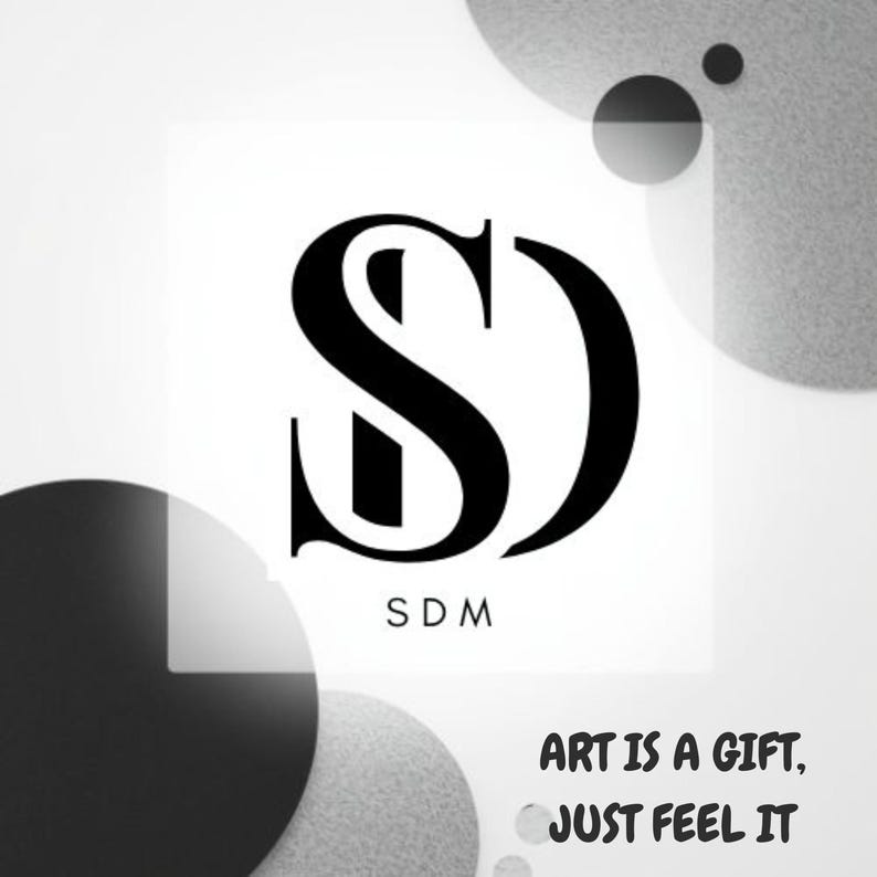May include: Black and white logo featuring the letters "SD" in a stylized font. Below the letters, the letters "SDM" are printed. The phrase "ART IS A GIFT, JUST FEEL IT" is printed below the logo, with a background of gray and black circles.