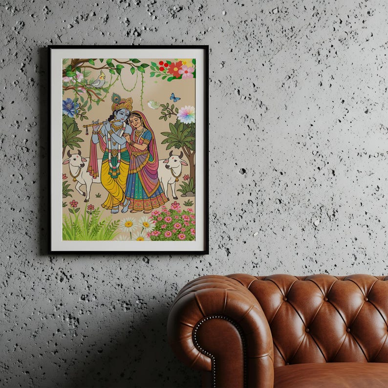 May include: A framed artwork depicting a colorful scene with two figures, possibly deities, in traditional Indian attire. The artwork features a pastoral setting with cows, flowers, and foliage, rendered in vibrant hues of yellow, blue, and pink.