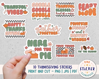May include: Ten Thanksgiving-themed stickers with various designs, including pumpkins, pies, and text. The stickers are printed on white paper with a glossy finish. The text on the stickers includes phrases like "Thankful Vibes", "Gobble Gobble", "Happy Thanks Giving", "Gather Together", "Here for the Pie", "Pumpkin Kisses", "Feast Mode", "Thick Thighs Pumpkin Pies", "Tis the Season", and "The Sticker Clubhouse".