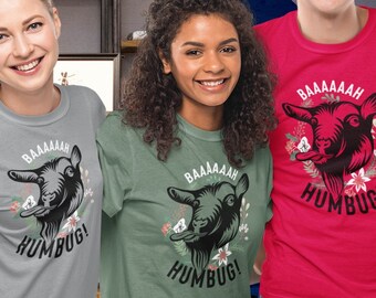 May include: Four people wearing t-shirts with a goat graphic and the text "BAAAAAAH HUMBUG!" The shirts are in different colors: gray, green, red, and light blue.
