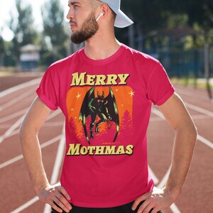 May include: A red t-shirt with a graphic of a monster with the text "MERRY MOTHMAS" printed on it.