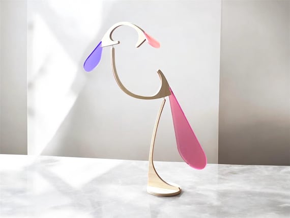 A handcrafted kinetic bird stabile that perches and sways hypnotically — the perfect executive desk toy that isn't a Newton's cradle.