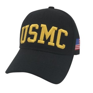 May include: A black baseball cap with a gold embroidered "USMC" logo and a small American flag on the side.