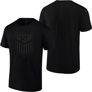 May include: Black t-shirt with a black and white USA crest graphic on the front.