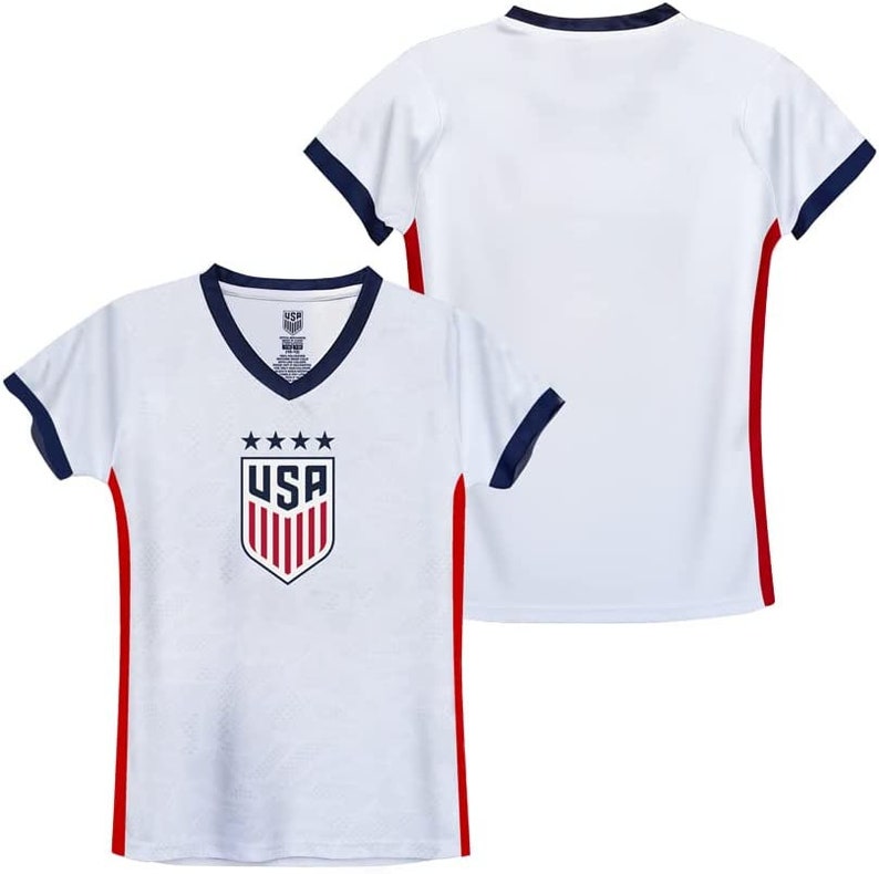 May include: White football shirt with red and navy blue trim. The shirt features the USA team logo with five stars and the word "USA" in red.