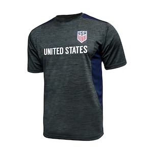 May include: A dark grey and navy blue short-sleeved t-shirt with the words "UNITED STATES" and a logo of the USA with the letters "USA" inside.