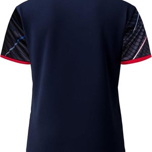 May include: Navy blue athletic shirt with a white collar and red trim on the sleeves. The sleeves have a black and gray pattern with blue and pink accents. The shirt is made of a breathable, textured fabric.