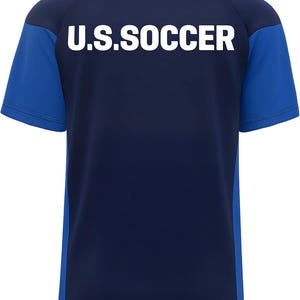 May include: Navy blue and royal blue soccer jersey with the text "U.S. SOCCER" in white block letters across the back. The jersey has short sleeves and a crew neck. The sleeves and side panels are royal blue.