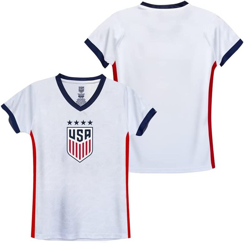 May include: White soccer jersey with red and navy blue trim. The jersey features the USA crest with five stars and the word "USA" in red.