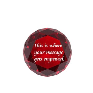 May include: A red crystal paperweight with the text "This is where your message gets engraved."