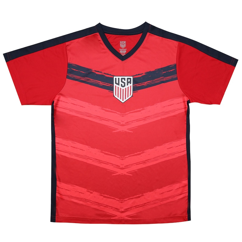 May include: Red soccer jersey with blue and white USA logo and black accents. The jersey has a V-neck and short sleeves.