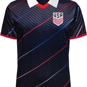 May include: A navy blue soccer jersey with a white collar and red trim. The jersey features diagonal stripes, red and blue accents, and a USA crest on the chest. The shirt has short sleeves.