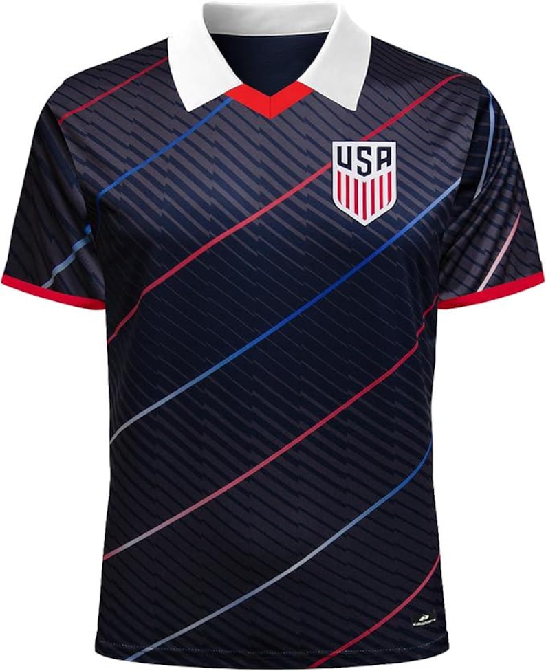 May include: A navy blue soccer jersey with a white collar and red trim. The jersey features diagonal stripes, red and blue accents, and a USA crest on the chest. The shirt has short sleeves.