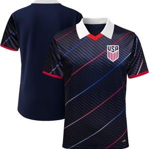 Peut inclure: Maillot de football bleu marine avec col blanc et bordure rouge. Le maillot pr&eacute;sente des rayures diagonales dans un motif sombre avec des accents rouges, blancs et bleus. Un &eacute;cusson USA est sur la poitrine.