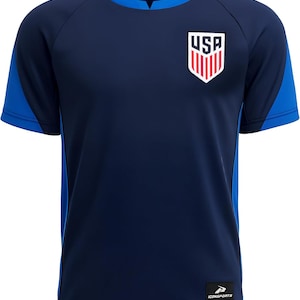 May include: Navy blue short-sleeve athletic shirt with blue accents on the sleeves and sides. Features a USA crest on the chest. The shirt has a crew neck and a small logo on the lower right.