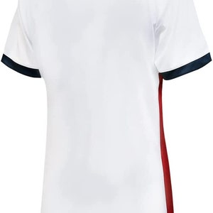 May include: White football shirt with navy blue trim on the collar and sleeves. The shirt has a red stripe down the right side.