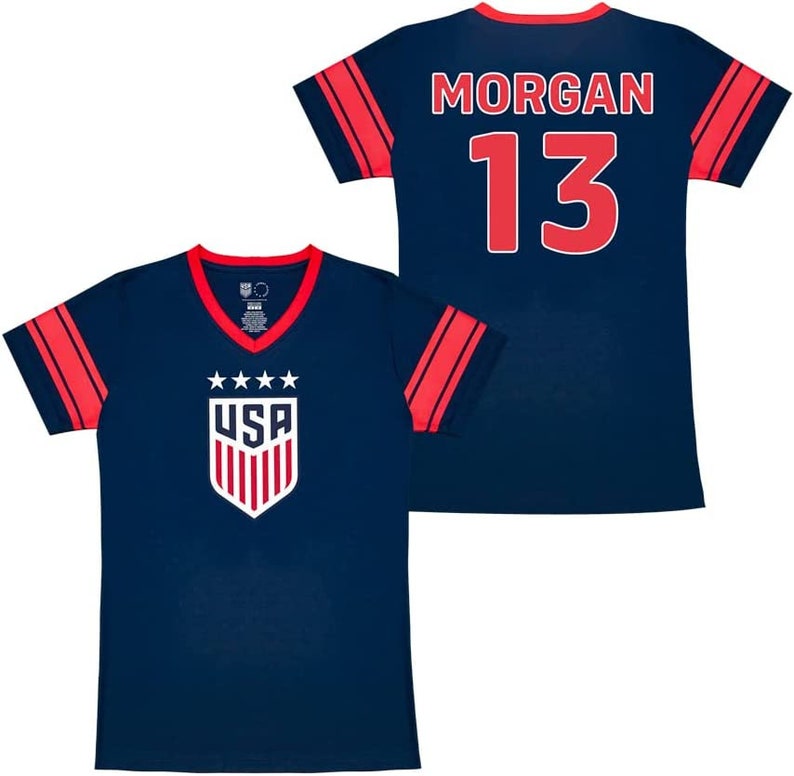 May include: Two navy blue soccer jerseys with red and white accents. One jersey has the text "USA" and a shield with stars. The other jersey has the text "MORGAN 13".