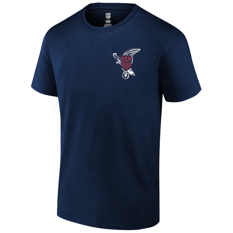 May include: A navy blue t-shirt with a white graphic of an eagle holding a soccer ball and a shield with the word "USA" on it.